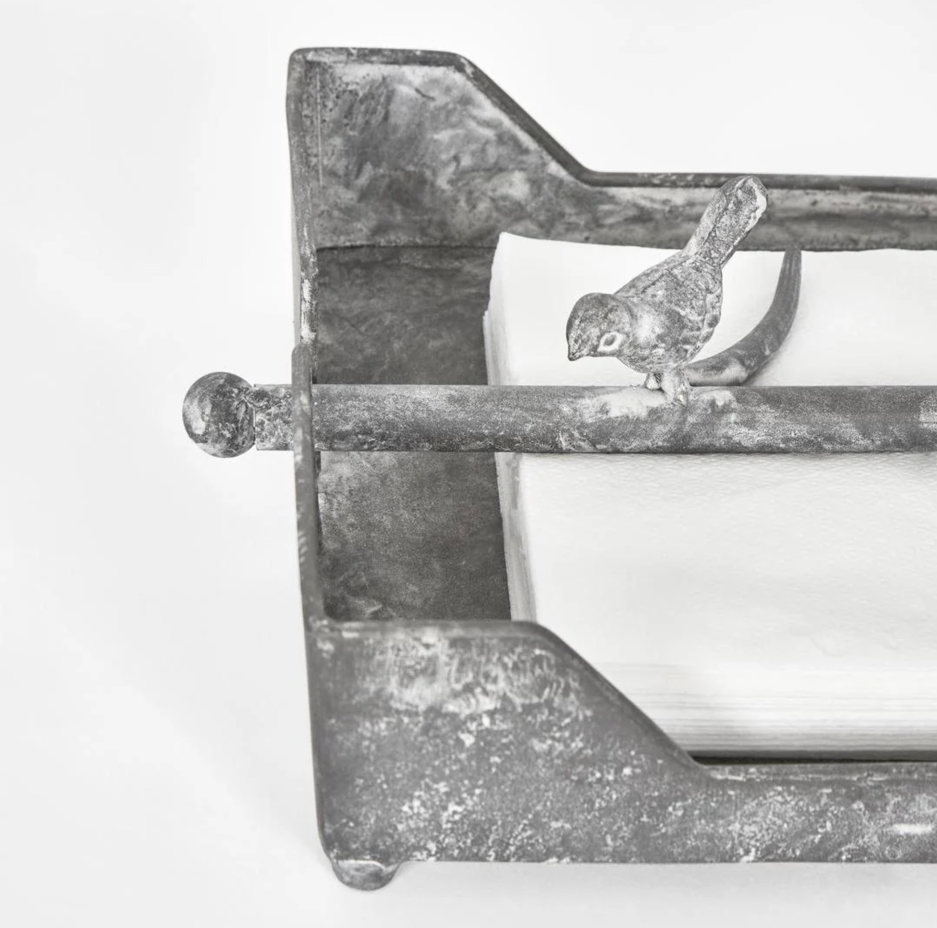 Close view of the bird details on the burgundy iron napkin holder