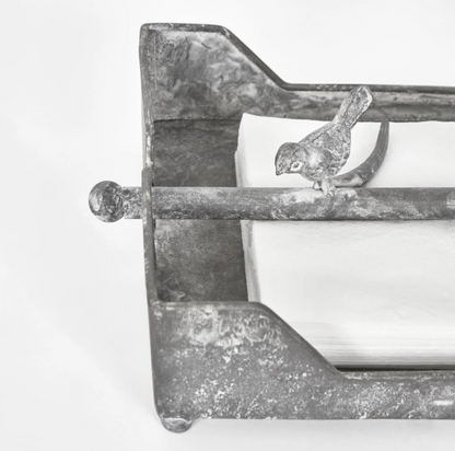 Close view of the bird details on the burgundy iron napkin holder
