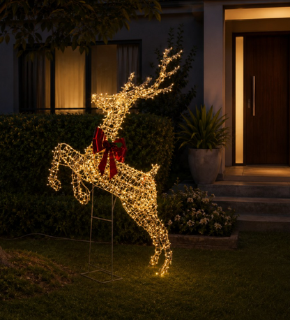 Light-up rearing reindeer with warm white twinkle lights and red bow