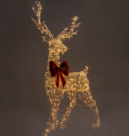 Front view of illuminated light reindeer with red bow