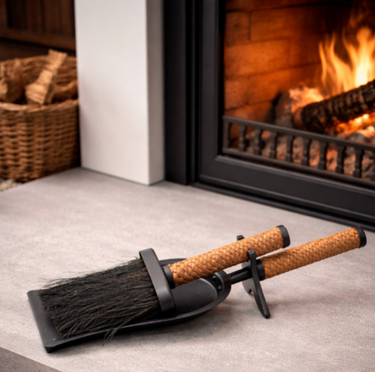 Fireplace shovel and brush set styled beside a lit fireplace