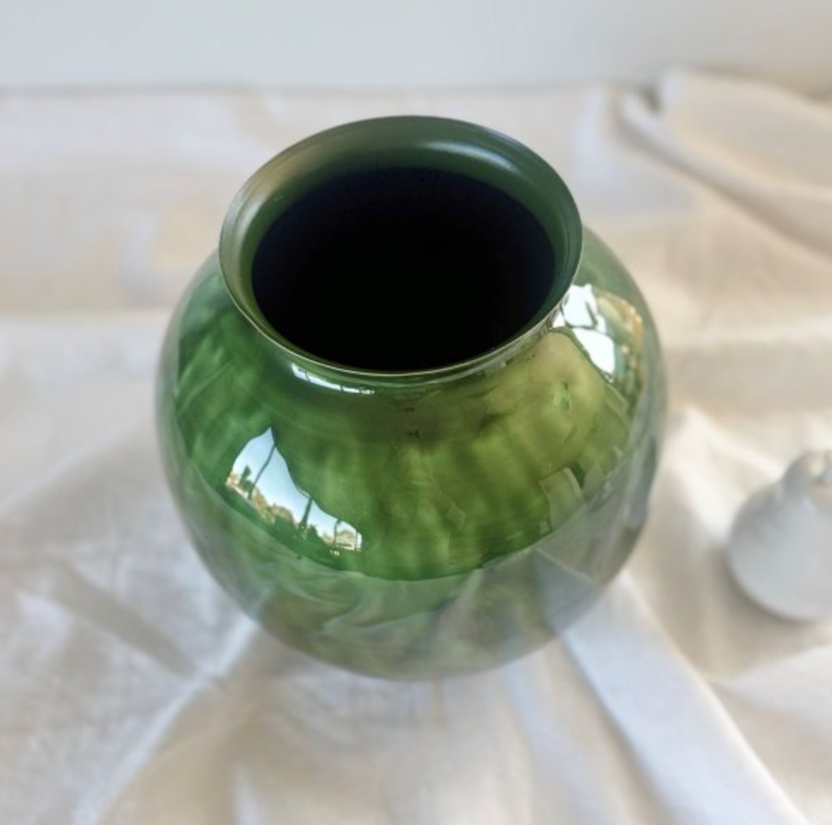Close-up of glossy green decorative vase