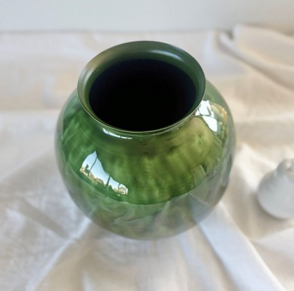 Close-up of glossy green decorative vase