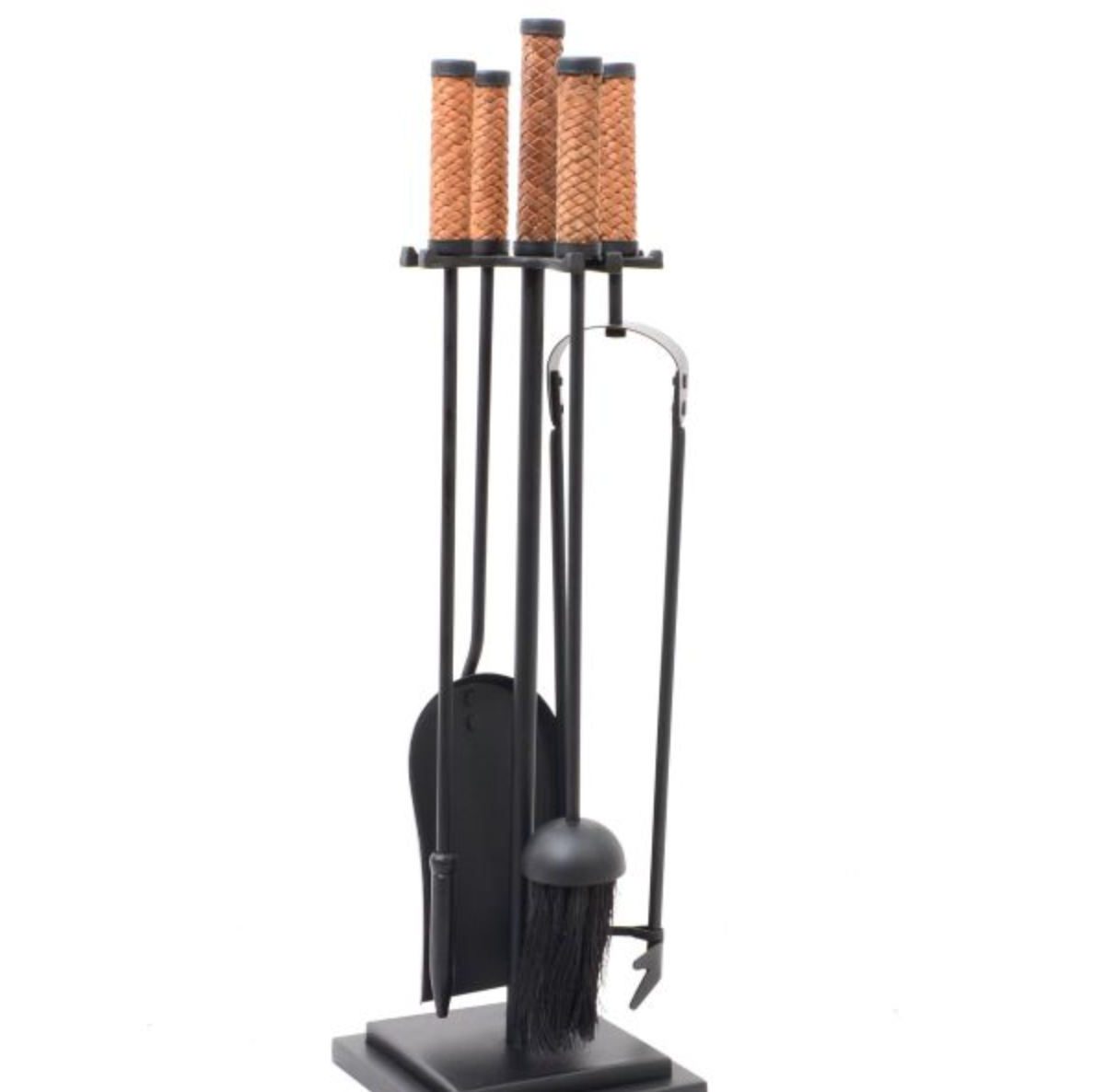Five-piece fire tool set standing beside a fireplace