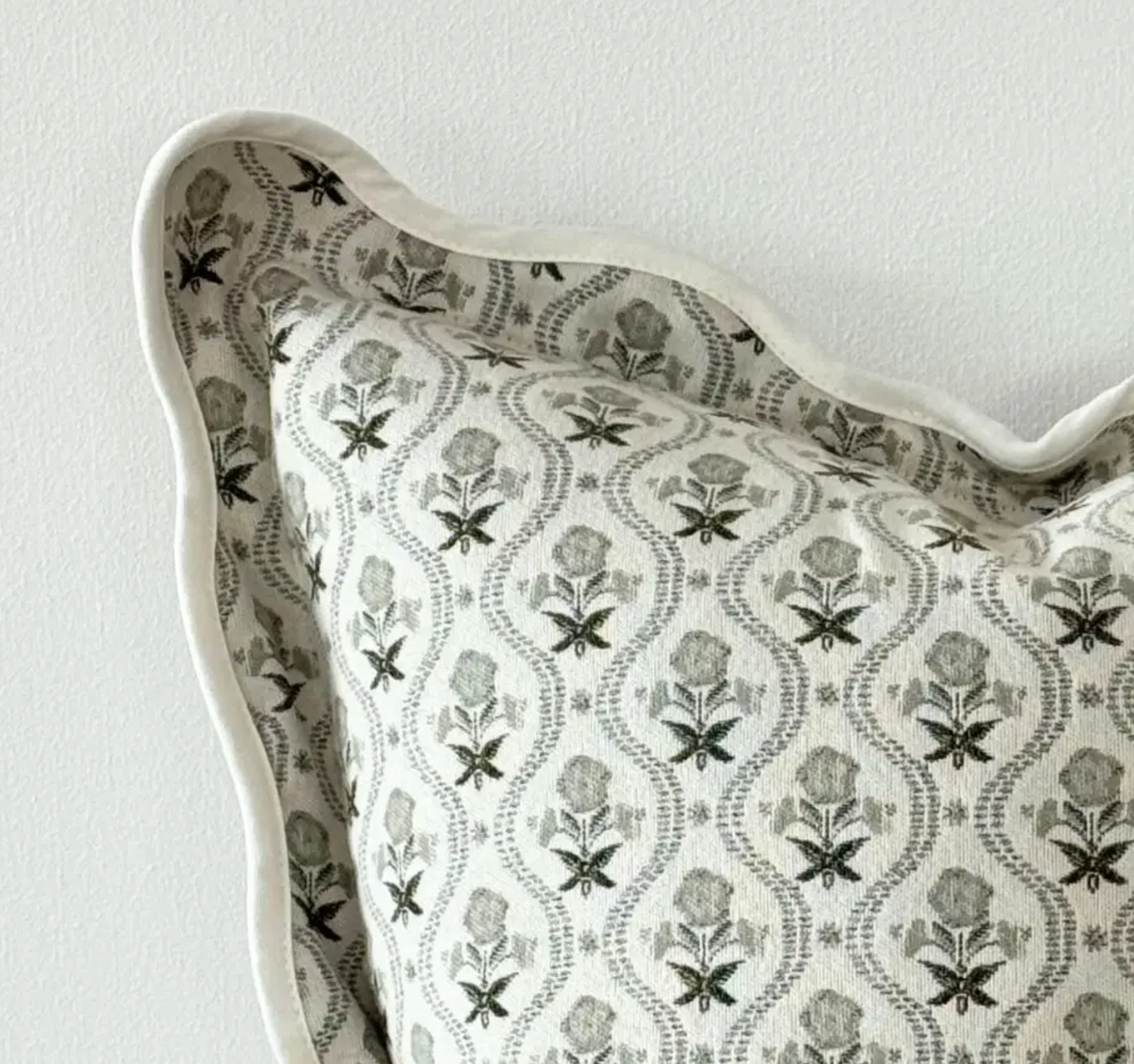 Sage and cream floral square scalloped edge cushion with feather insert on a white background