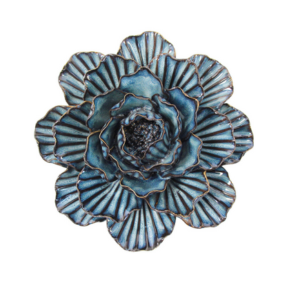 Back of an inky blue ceramic wall flower showing the hanging slot.