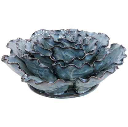 Front view of a large blue and teal ceramic ocean wall flower with gold-edged petals on a white background.