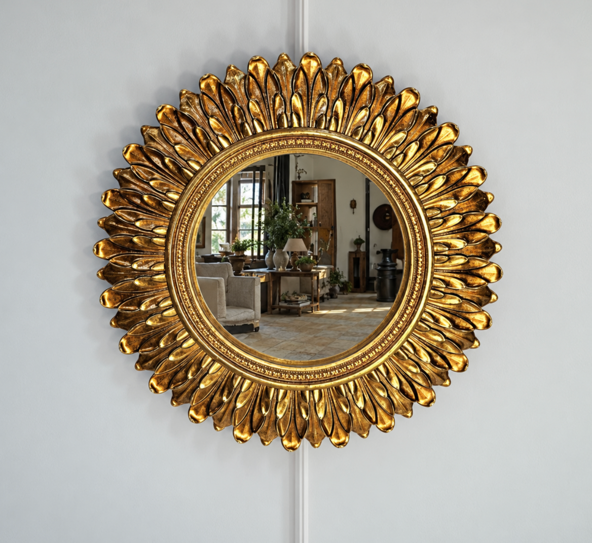 Gold mirror with an ornate frame of layered acanthus leaf detailing