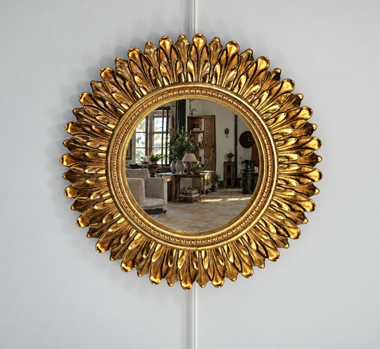 Gold mirror with an ornate frame of layered acanthus leaf detailing