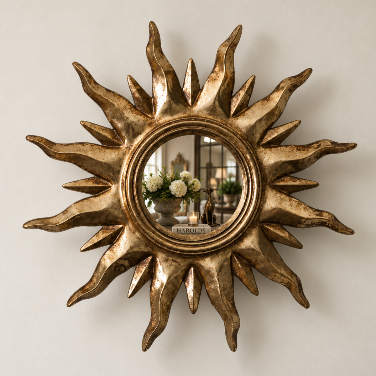 Small gold sunburst mirror with a painted timber frame and round central mirror