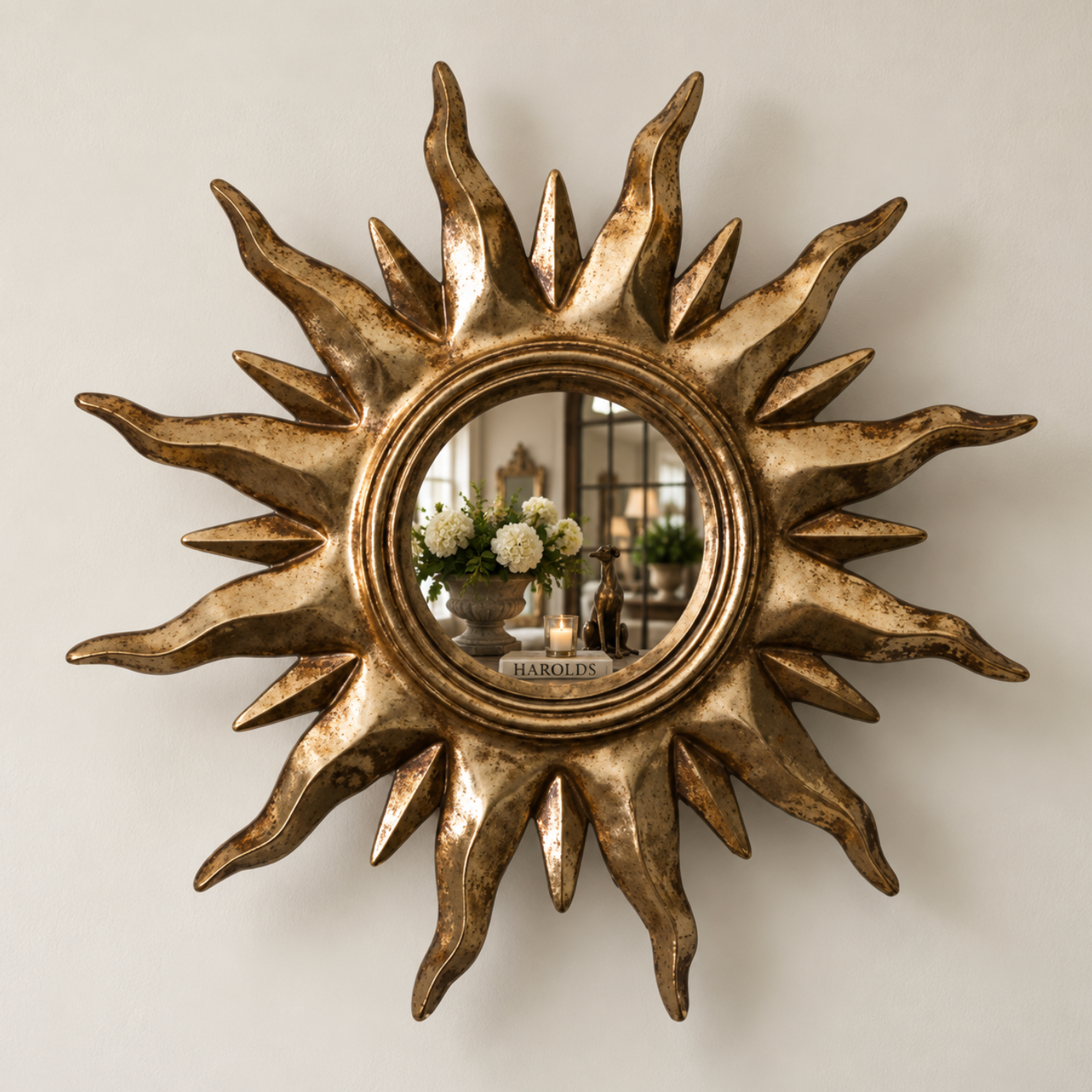 Small gold sunburst mirror with a painted timber frame and round central mirror