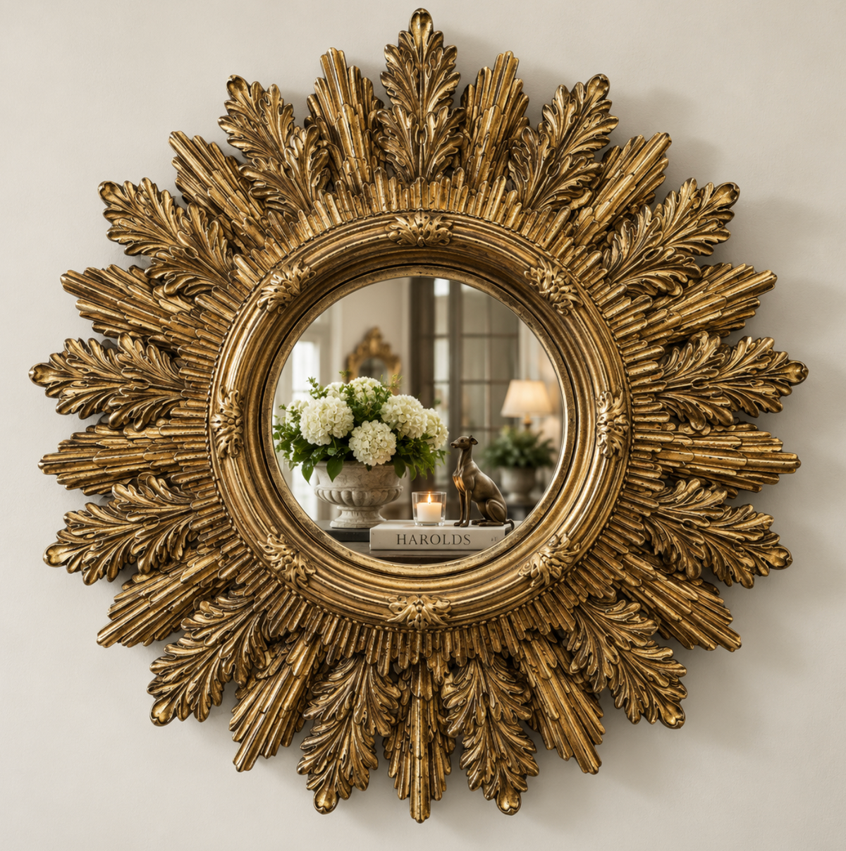 Gold mirror with an ornate acanthus leaf frame and painted timber finish