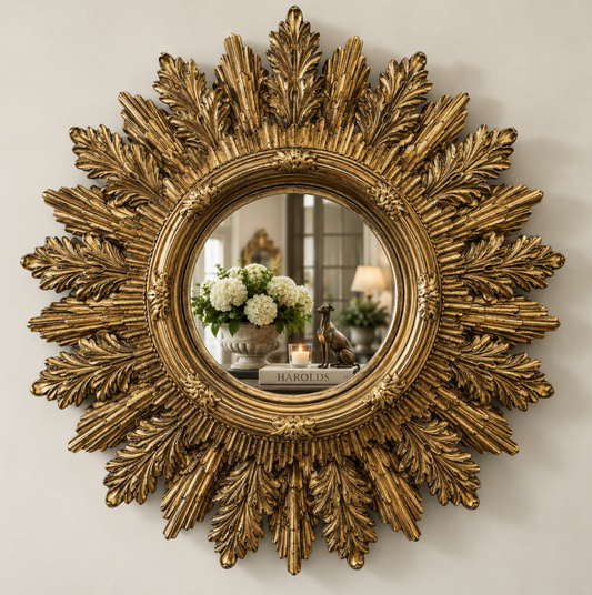 Gold mirror with an ornate acanthus leaf frame and painted timber finish