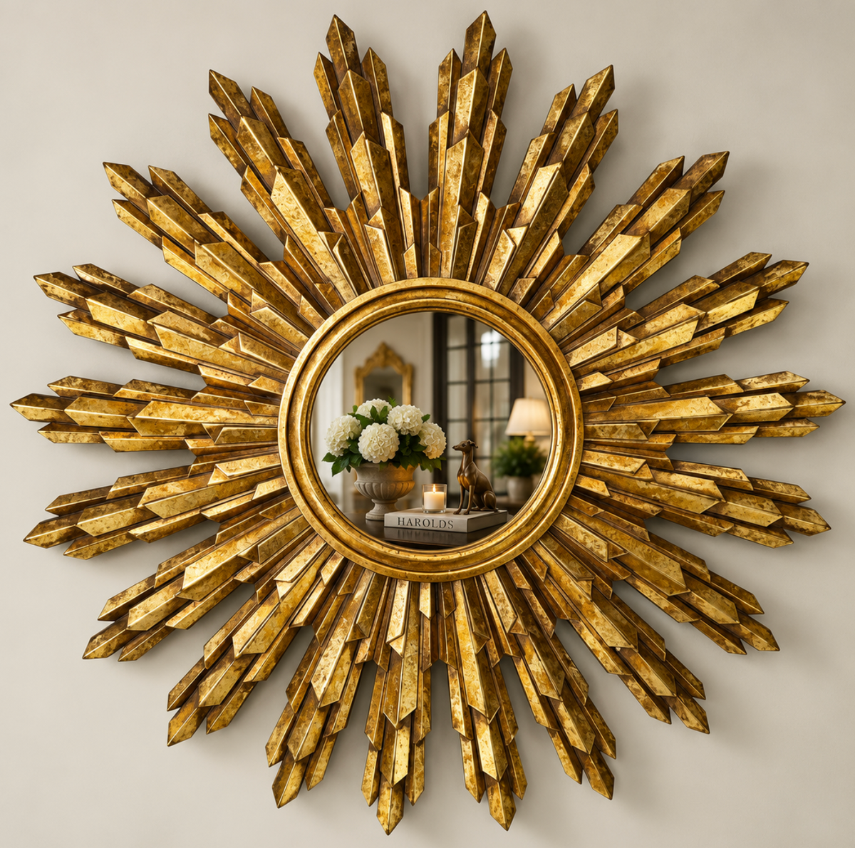 Gold-toned painted timber sunburst mirror on a neutral wall
