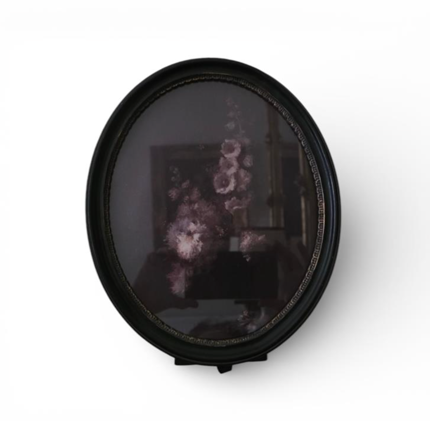 Oval black frame displaying a dark floral image with pink and mauve flowers