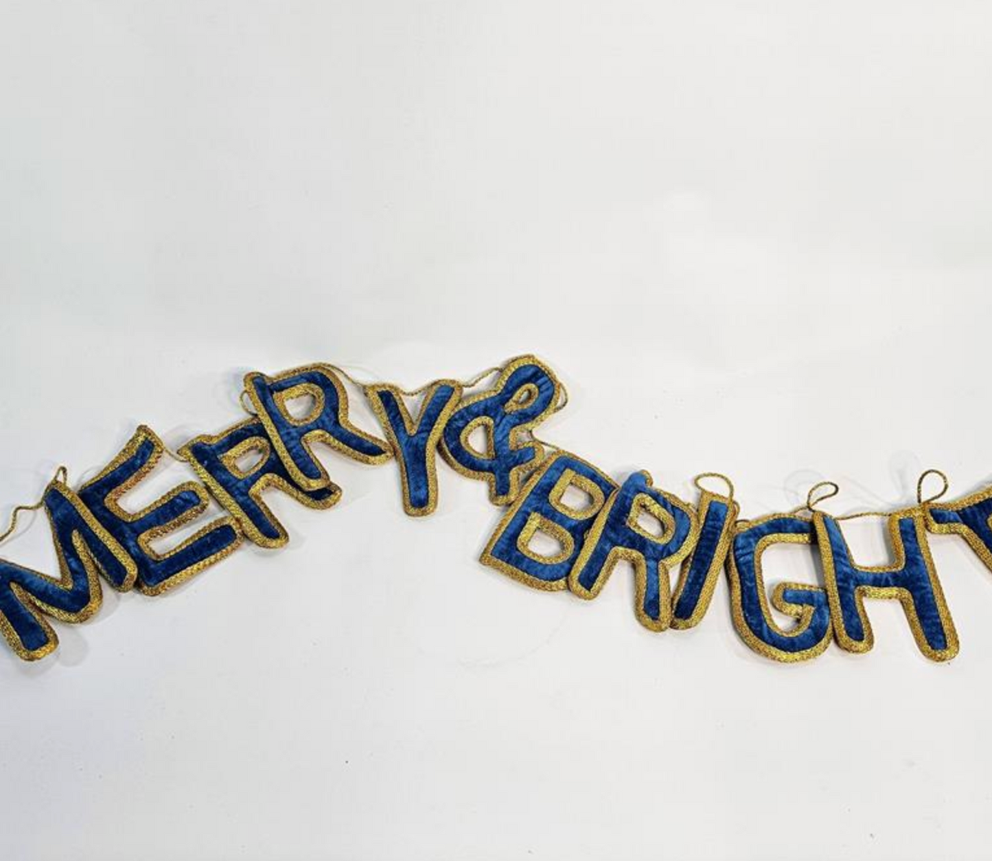 Royal blue velvet garland spelling Merry and Bright with gold edging