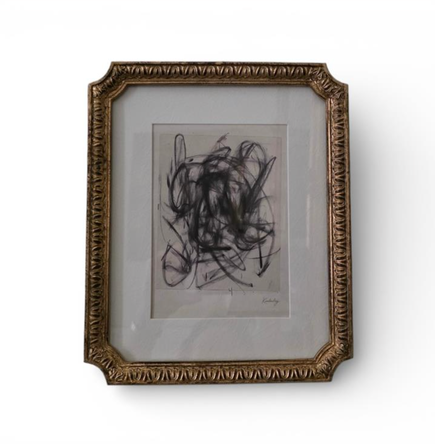 Ornate brown and gold-toned frame holding an abstract monochrome artwork