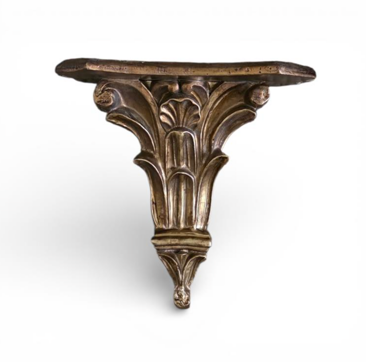 Dark bronze-toned ornate wall shelf with scrolling foliage and a shaped ledge
