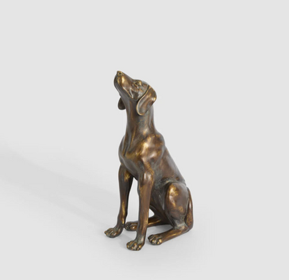 Close view of the sitting dog sculpture in antique finish