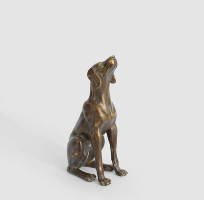 Sitting dog sculpture in antique finish shown in three-quarter view