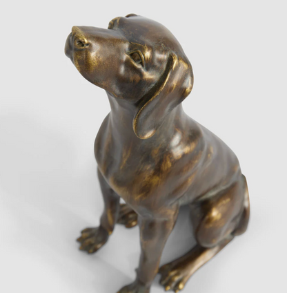Sitting dog sculpture in antique finish viewed from the side