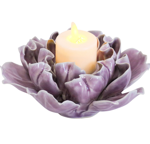 Mauve ceramic flower-petal tealight holder with a candle shown in the centre