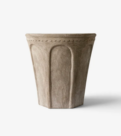 Sand Terra Arc Planters in three sizes displayed with plants in an outdoor setting.