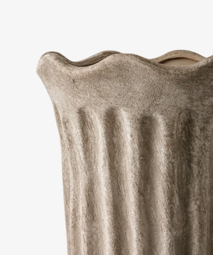 Close view of the Fluted Vase in sand terracotta showing its sculpted panels and undulating rim