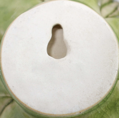 Back of mist ceramic wall flower showing keyhole hanger