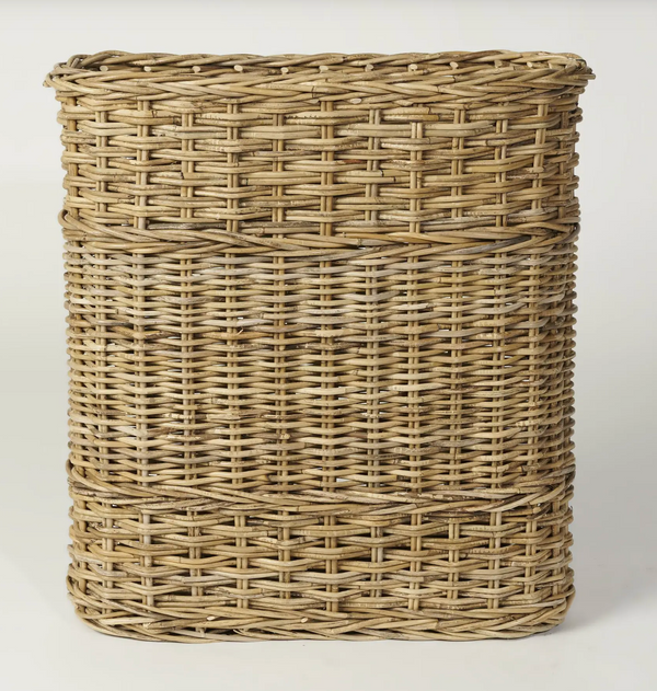 Person holding oval woven umbrella stand to show its scale