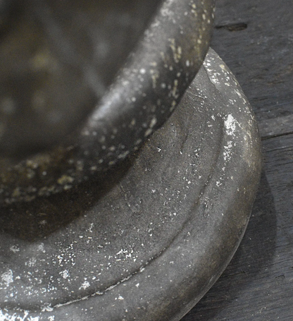 Close-up of weathered cement bust surface and drapery