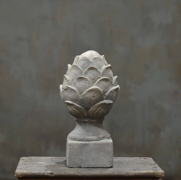Pineapple finial with weathered stone finish on square base, front view
