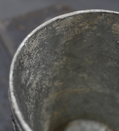 Close-up of tin flower pot interior and rim