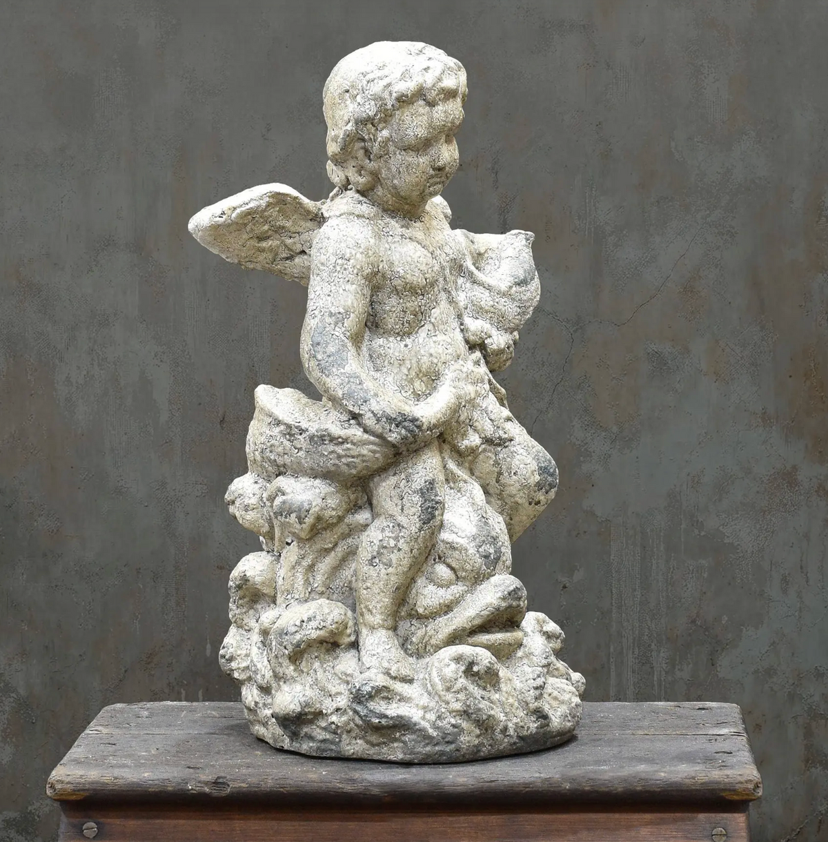Standing cherub statue, front three-quarter view