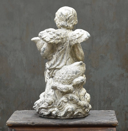 Cherub statue holding drapery, side view