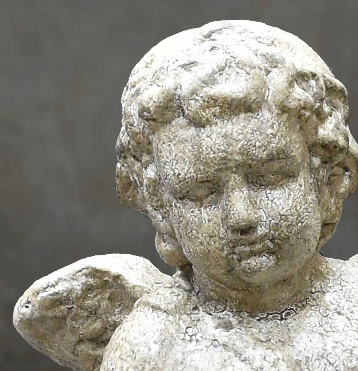 Close-up of cherub statue base and sculptural detail