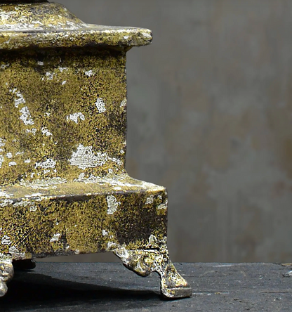 Close-up of gold candlestick stepped base and feet