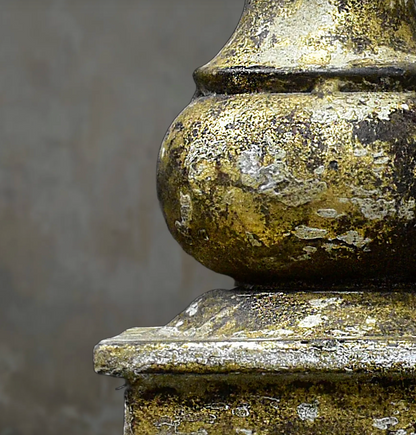 Close-up of gold candlestick rounded stem and patina