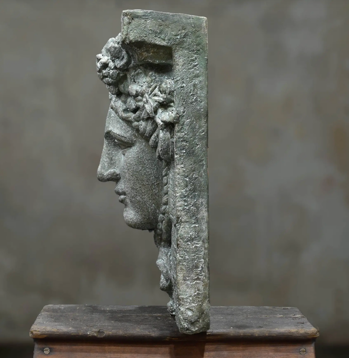 Close-up of Hermes wall plaque face and laurel detail