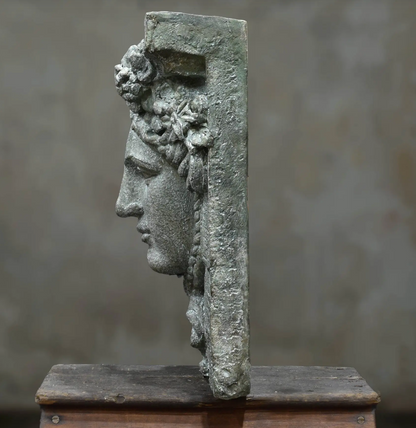 Close-up of Hermes wall plaque face and laurel detail