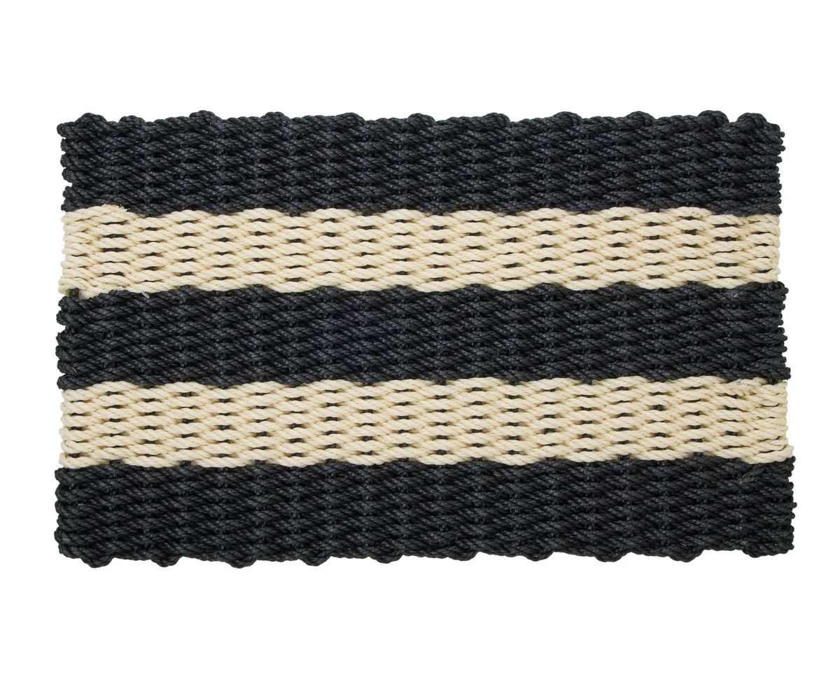 Black and cream striped rope door mat placed at a doorway