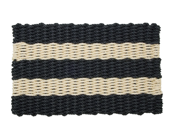 Black and cream striped rope door mat placed at a doorway