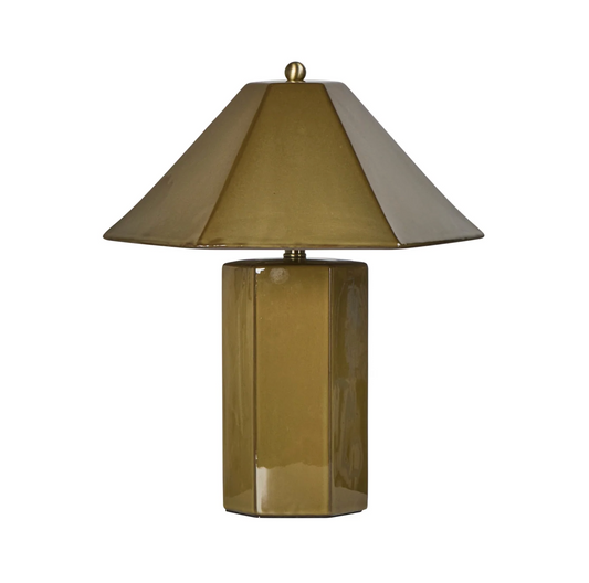 Green faceted table lamp on a side table beside a brown armchair