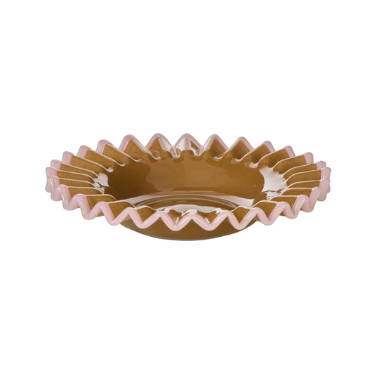 Side view of shallow mustard glass dish with a pink frilled rim