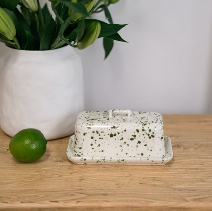 Green splatter butter dish with lid lifted to show the matching base