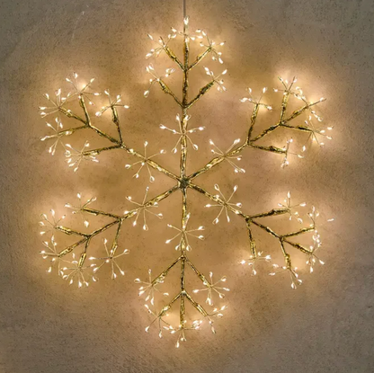 Close-up of a snowflake light's metal branches and warm white LED tips