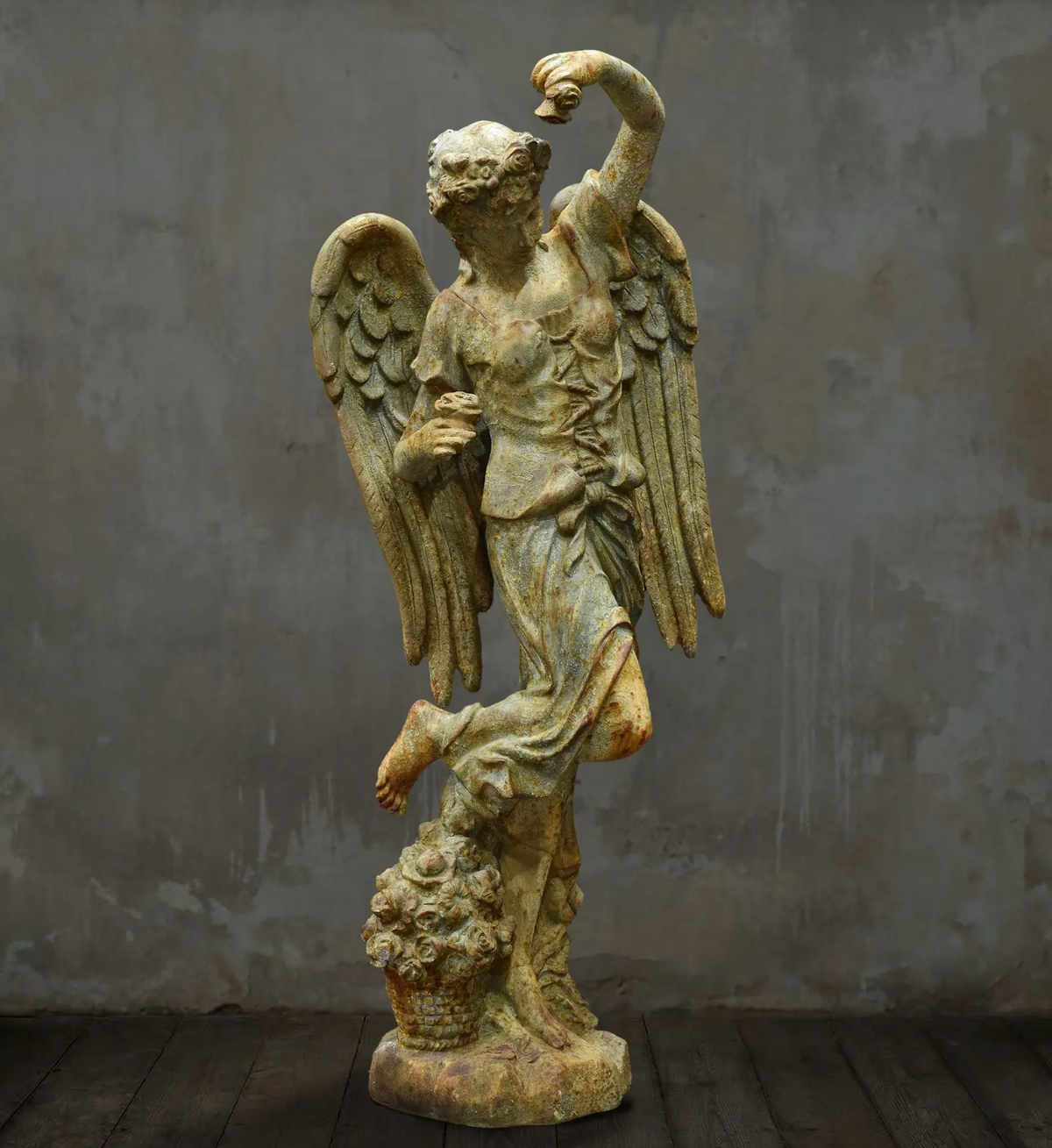 Close-up of angel statue face and floral hair detail
