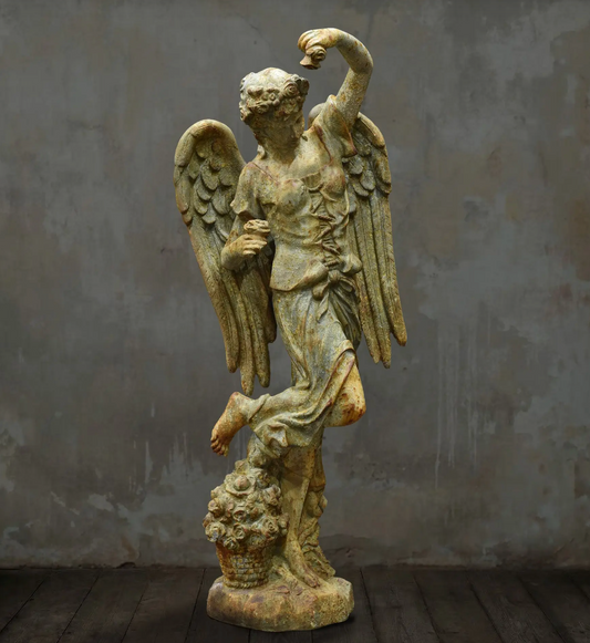 Close-up of angel statue face and floral hair detail