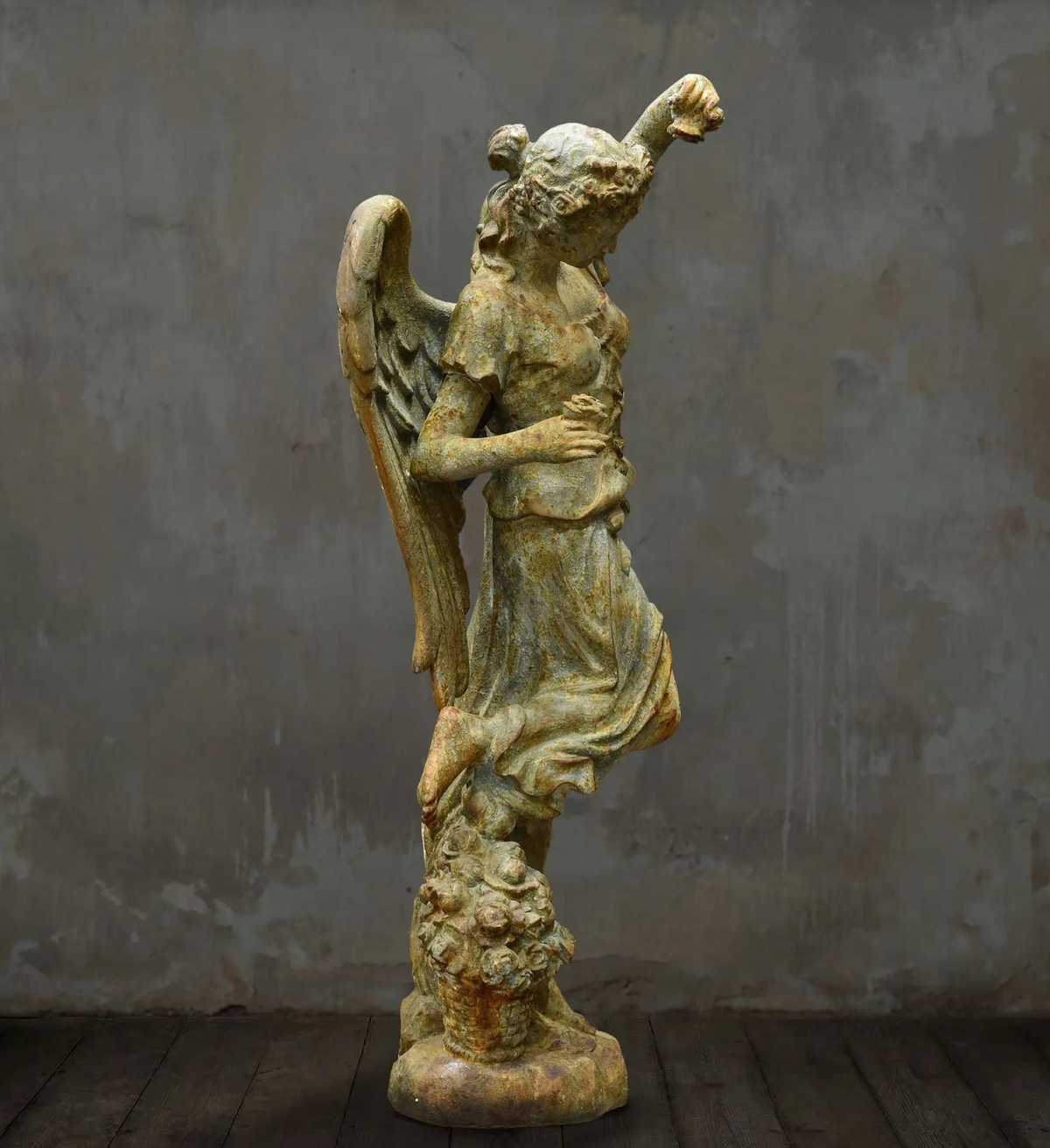 Rear angled view of angel statue and sculpted floral base