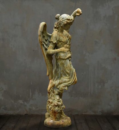 Rear angled view of angel statue and sculpted floral base